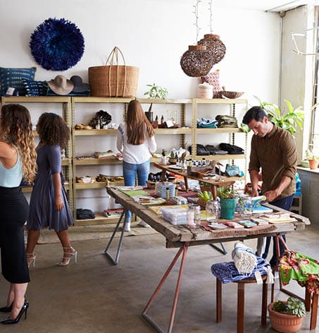 Individuals shopping in a boho-styled boutique.