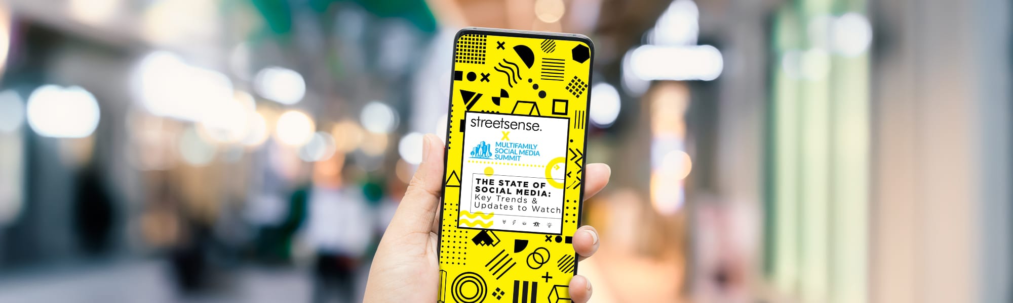 photo of a smartphone with a graphic on it that states "Streetsense. Multifamily Social Media Summit. The State of Social Media: Key Trends & Updates to Watch