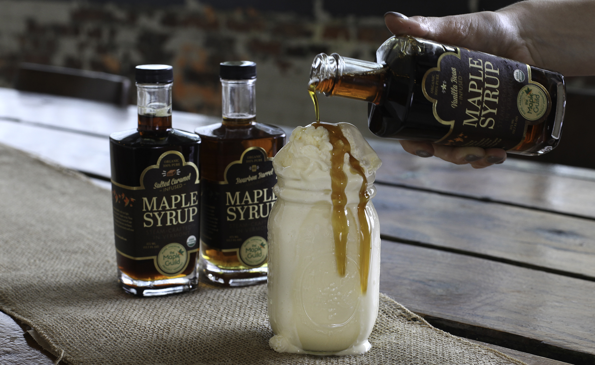 maple syrup being poured over whipped cream drink