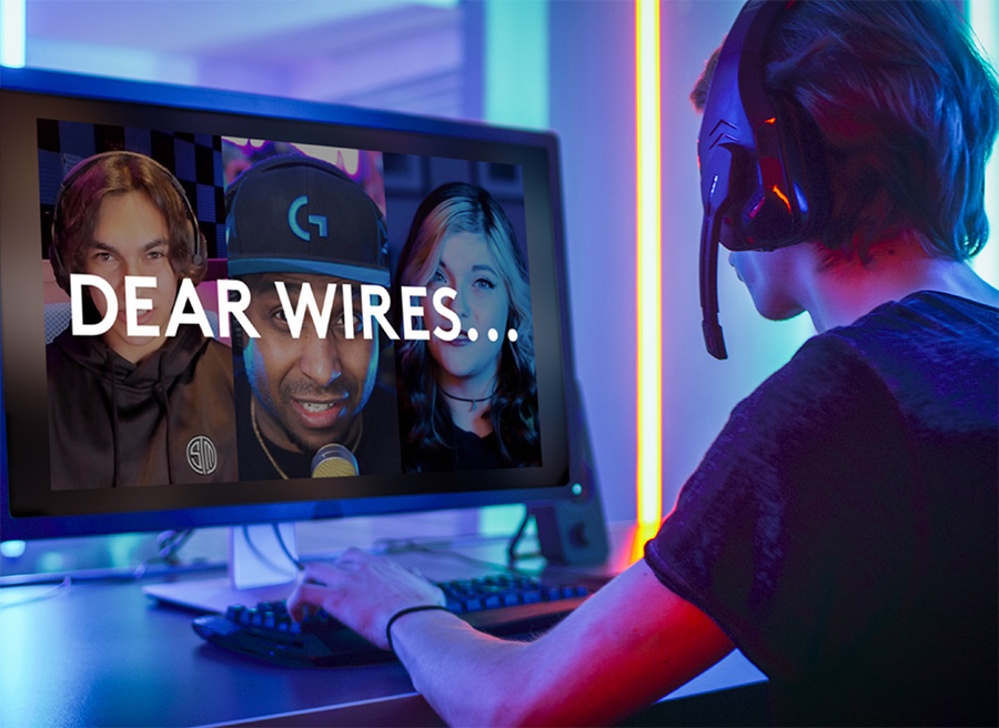 dear wires text on computer with man with headphones sitting in front of it