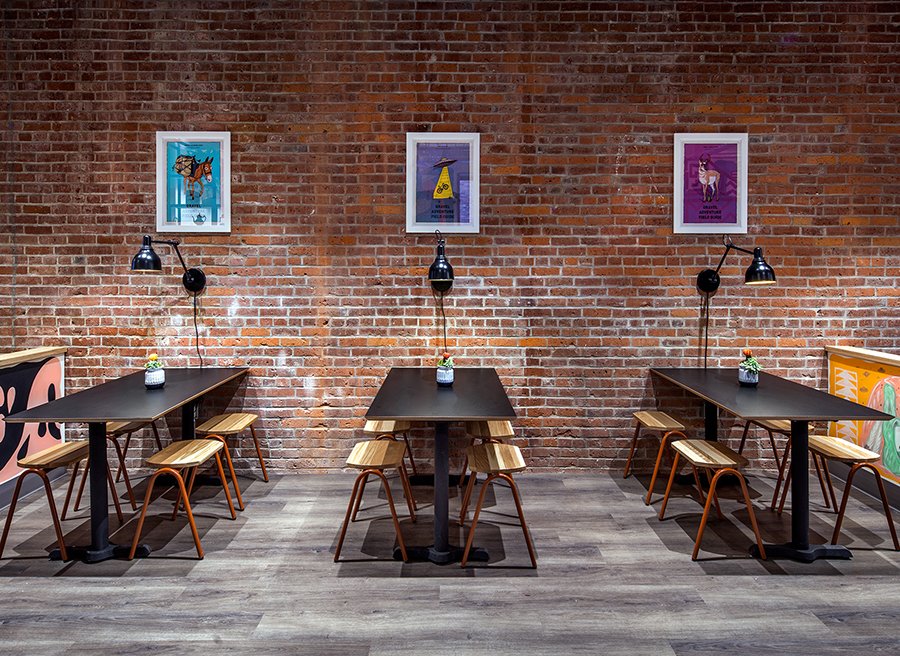 long tables with cool art and exposed brick