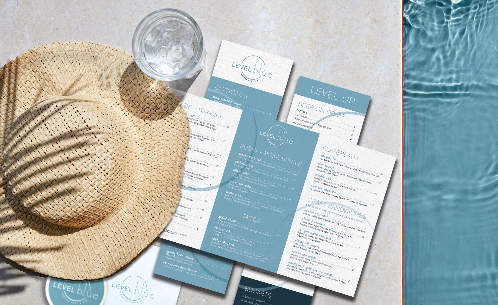 blue and white pamphlets with sunhat and glass