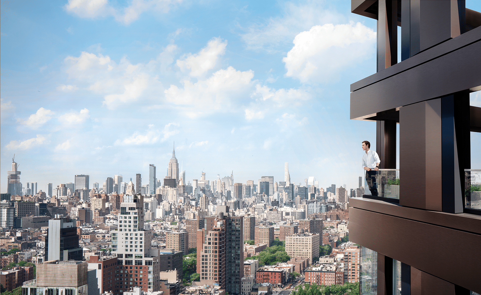 man standing on edge of balcony overlooking manhattan skyline