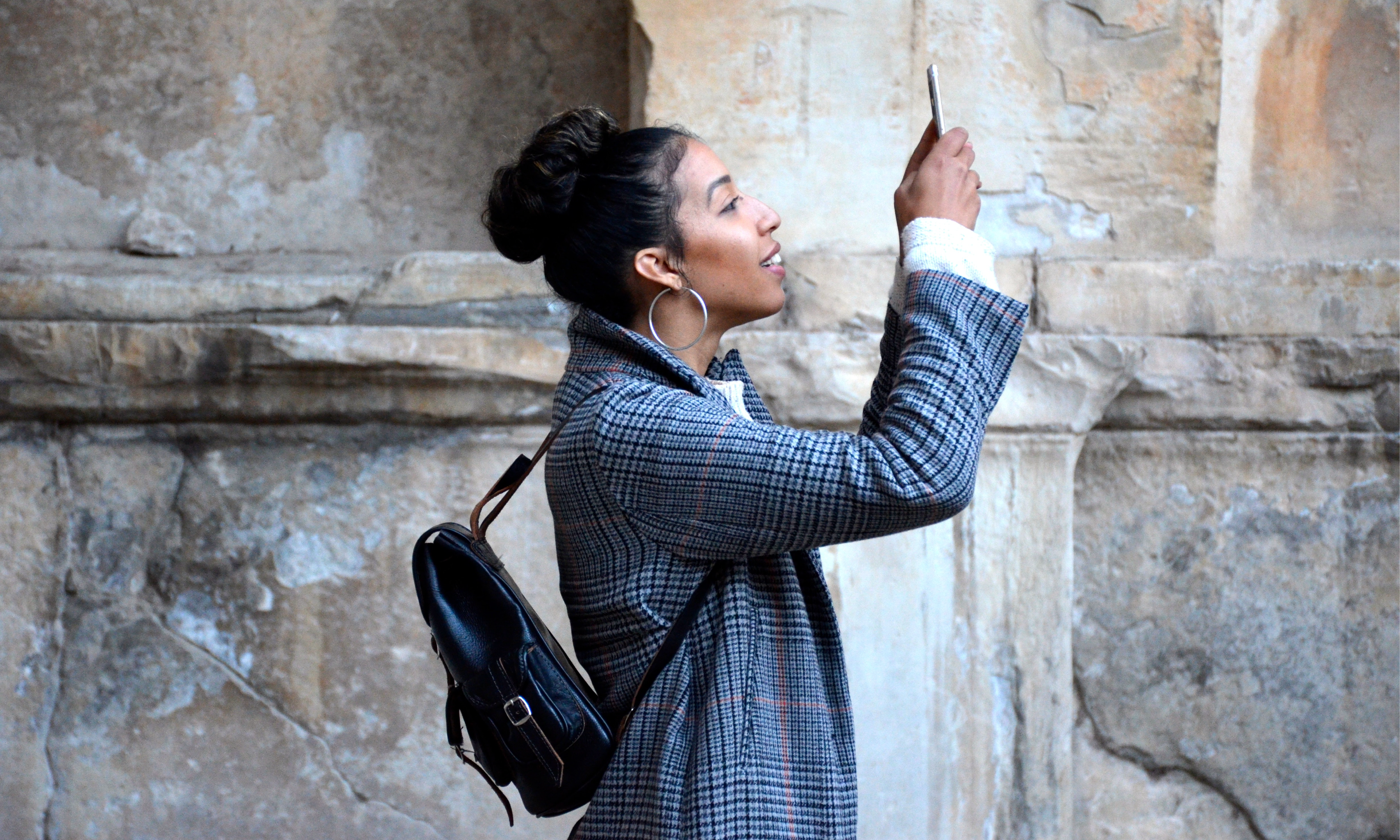 A woman takes a picture with her mobile phone.